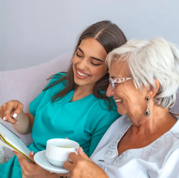 A woman and an older lady sitting on the couch